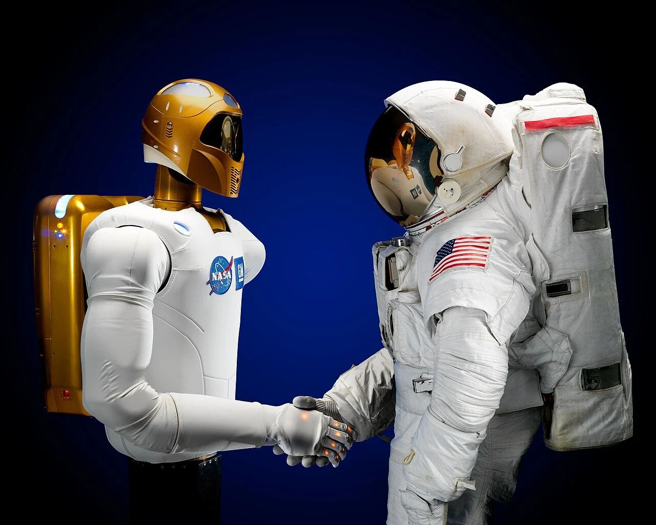 Robonaut 2 shaking hands with an astronaut