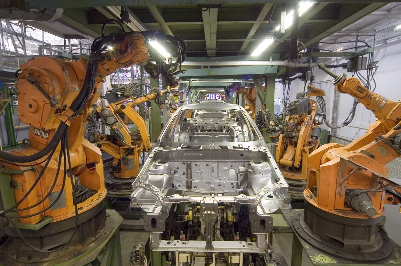 Archive photograph of KUKA robots on a car body assembly line